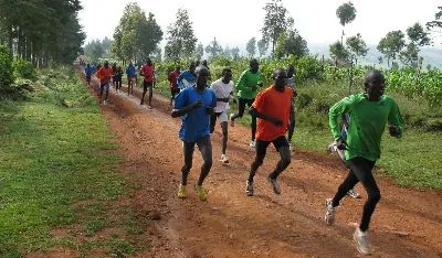 Runners training together on a dirt road in Kenya